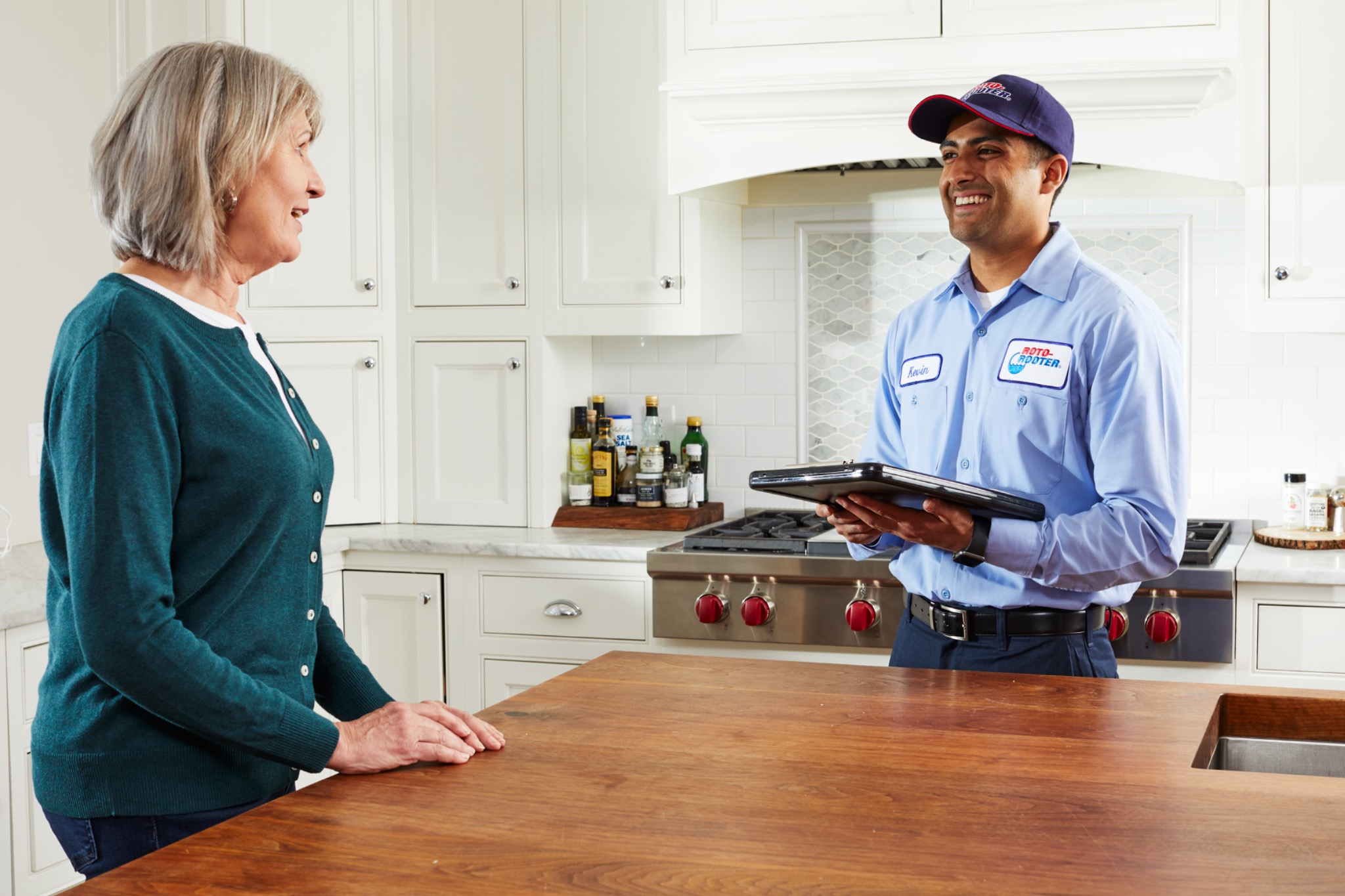 Roto-Rooter technician reviewing financing options with customer