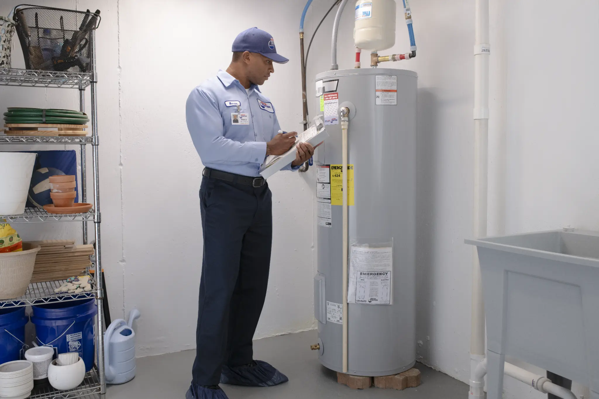 Roto-Rooter technician inspecting a water heater